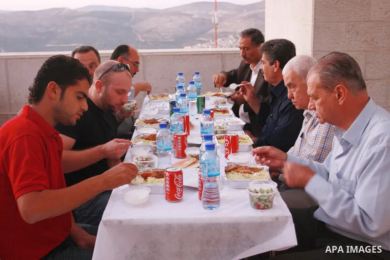 Palestinians take part in the Central Ramadan breakfast for the first orphanage, organized by the United Arab Emirates State charity , in the West Bank city of Nablus, monday Aug . 22,2011. Muslims throughout the world a...