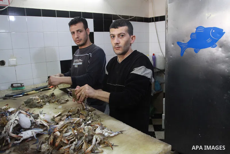 In this photo taken on May 5, 2011: Palestinian assistants Chef prepare fish at the Moneer abu Hassira restaurant in Gaza city, ordinary people and politicians alike are served top-class seafood at the Moneer abu Hassira...