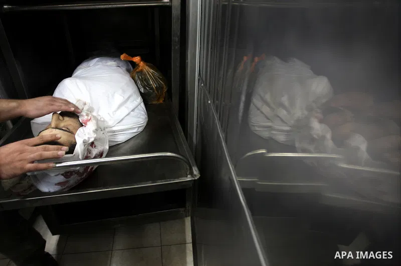 Palestinian relatives mourn over the body of Islamic Jihad militant Ismael Al-Asmar at Rafah hospital after an Israeli air strike hit his car in Rafah in the southern Gaza Strip on 24 August 2011. Al-Asmar, one of the mi...