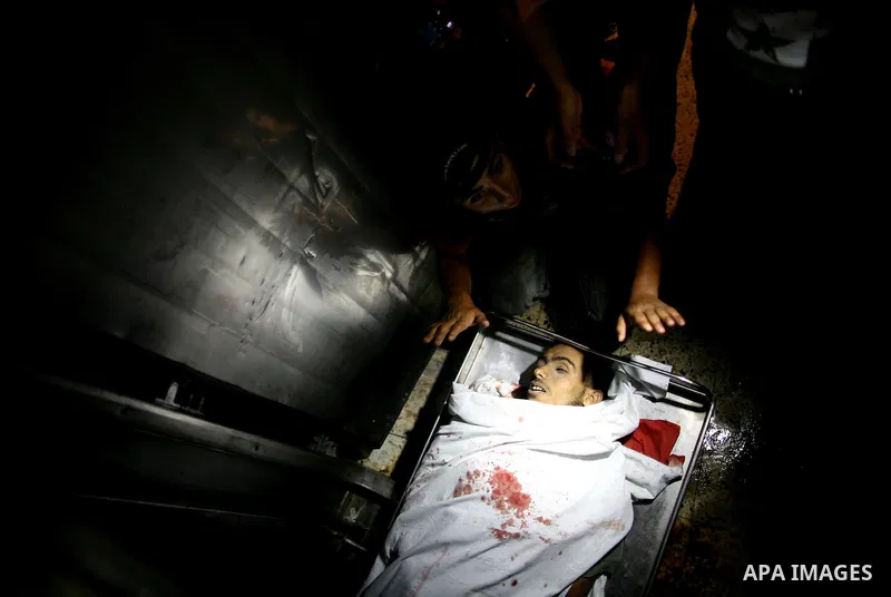Palestinian relatives mourn over the body of Islamic Jihad militant Atia Moqat at El-shifa hospital after an Israeli air strike in Gaza City on 24 August 2011. Photo by Mahmud Nassar
