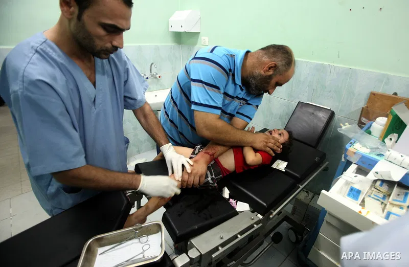Palestinians carry a wounded girl into Shuhada El- Aqsa hospital following Israeli shell in Gaza, Aug. 25, 2011. Photo by Ali Jadallah