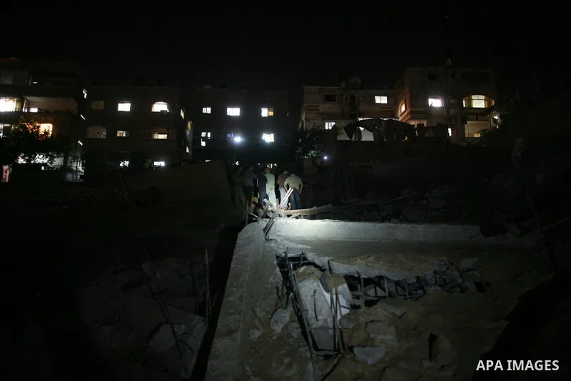 Palestinians inspect the damage at a club following an Israeli air strike in Gaza City, on Aug. 25, 2011. Israeli air strikes killed two Gaza militants, one a local commander of the Islamic Jihad group in the Gaza Strip,...