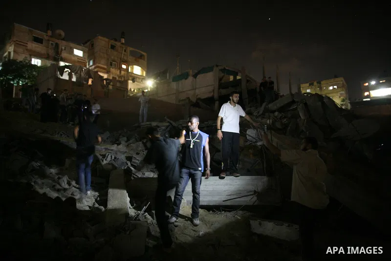 Palestinians inspect the damage at a club following an Israeli air strike in Gaza City, on Aug. 25, 2011. Israeli air strikes killed two Gaza militants, one a local commander of the Islamic Jihad group in the Gaza Strip,...