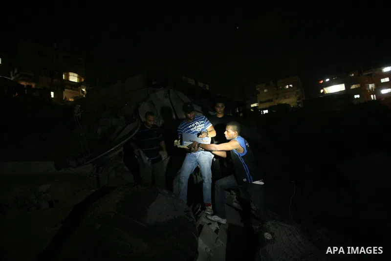 Palestinians inspect the damage at a club following an Israeli air strike in Gaza City, on Aug. 25, 2011. Israeli air strikes killed two Gaza militants, one a local commander of the Islamic Jihad group in the Gaza Strip,...
