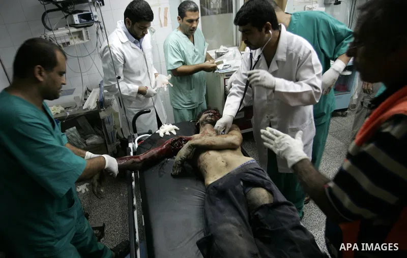 Palestinians doctors attend a wounded man at the Al Najar hospital following an Israeli air strike on a smuggling tunnel in Rafah, southern Gaza Strip, Thursday, Aug. 25, 2011. The Israeli military said its aircraft hit...