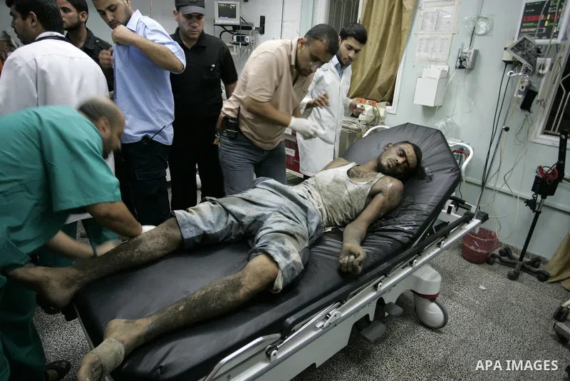 Palestinians doctors attend a wounded man at the Al Najar hospital following an Israeli air strike on a smuggling tunnel in Rafah, southern Gaza Strip, Thursday, Aug. 25, 2011. The Israeli military said its aircraft hit...