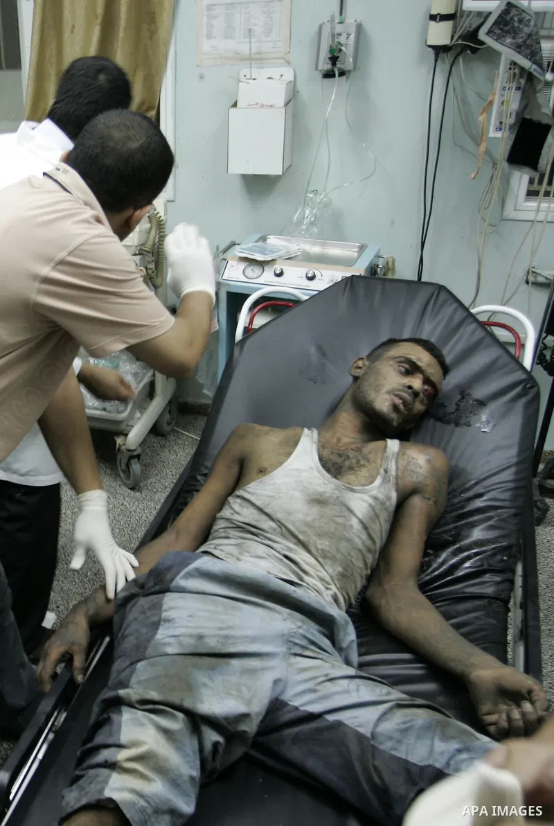 Palestinians doctors attend a wounded man at the Al Najar hospital following an Israeli air strike on a smuggling tunnel in Rafah, southern Gaza Strip, Thursday, Aug. 25, 2011. The Israeli military said its aircraft hit...