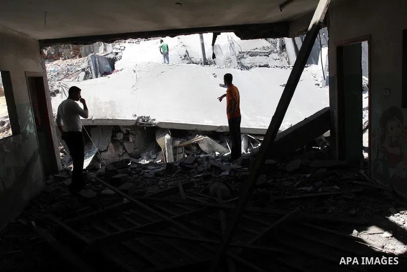 Palestinians inspect the grounds of a sporting club and the homes of some citizens that was destroyed by an overnight Israeli air raid in Beit Lahia, on August 25, 2011. A series of Israeli air strikes on Gaza over the p...