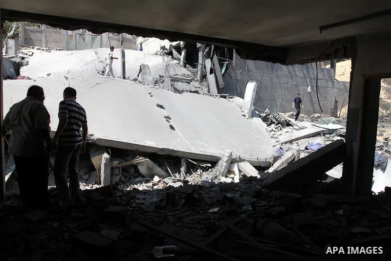 Palestinians inspect the grounds of a sporting club and the homes of some citizens that was destroyed by an overnight Israeli air raid in Beit Lahia, on August 25, 2011. A series of Israeli air strikes on Gaza over the p...