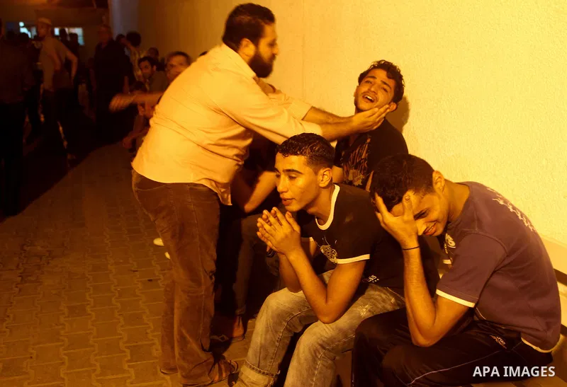 Palestinians mourn the body of Salem al-Arabed following an Israeli air strike killing two Islamic Jihad militants, at the main road in Jabaliya, northern Gaza Strip, Thursday, Aug. 25, 2011. Palestinian official said th...