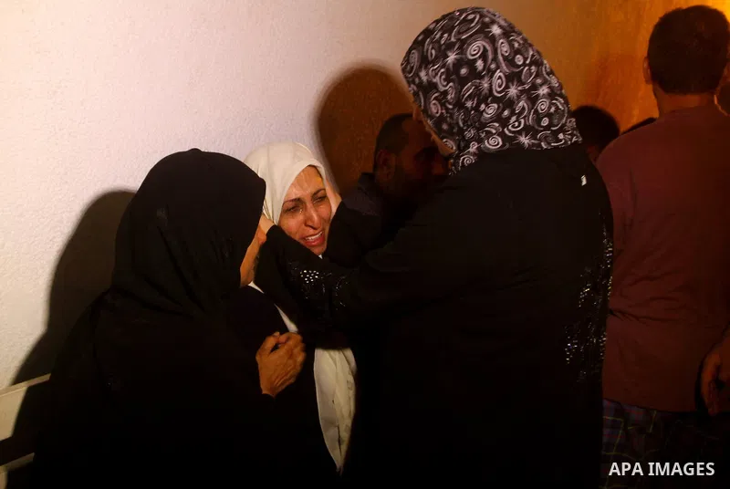 Palestinians mourn the body of Salem al-Arabed following an Israeli air strike killing two Islamic Jihad militants, at the main road in Jabaliya, northern Gaza Strip, Thursday, Aug. 25, 2011. Palestinian official said th...