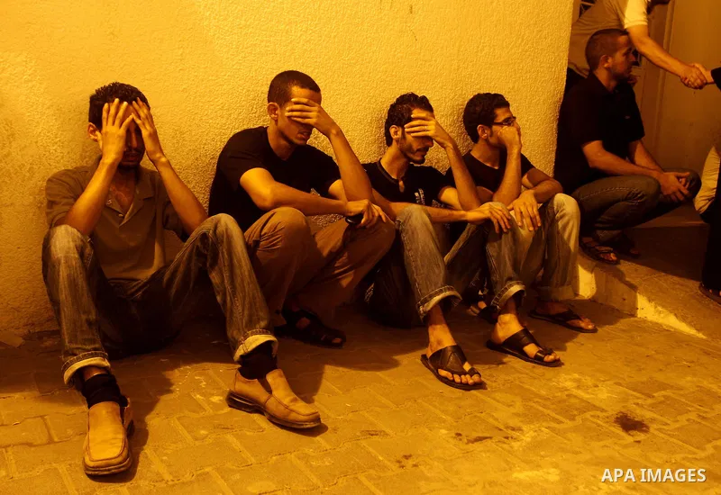 Palestinians mourn the body of Salem al-Arabed following an Israeli air strike killing two Islamic Jihad militants, at the main road in Jabaliya, northern Gaza Strip, Thursday, Aug. 25, 2011. Palestinian official said th...