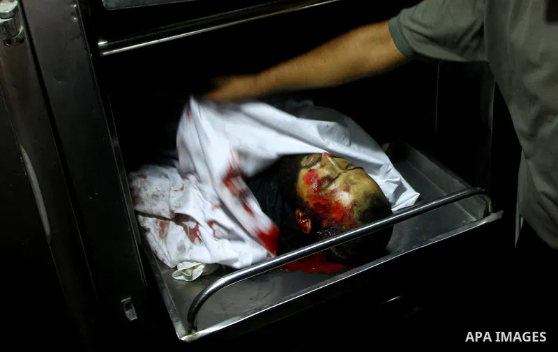 A Palestinian man mourn the body of Salem al-Arabed following an Israeli air strike killing two Islamic Jihad militants, at the main road in Jabaliya, northern Gaza Strip, Thursday, Aug. 25, 2011. Palestinian official sa...