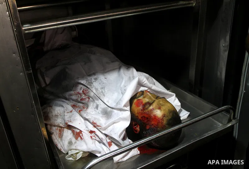 A Palestinian man mourn the body of Salem al-Arabed following an Israeli air strike killing two Islamic Jihad militants, at the main road in Jabaliya, northern Gaza Strip, Thursday, Aug. 25, 2011. Palestinian official sa...