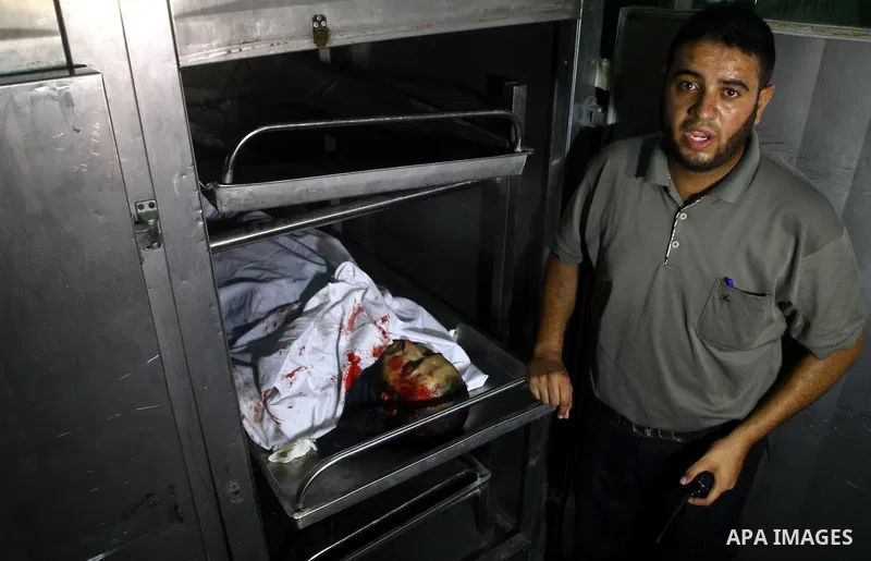 A Palestinian man mourn the body of Salem al-Arabed following an Israeli air strike killing two Islamic Jihad militants, at the main road in Jabaliya, northern Gaza Strip, Thursday, Aug. 25, 2011. Palestinian official sa...