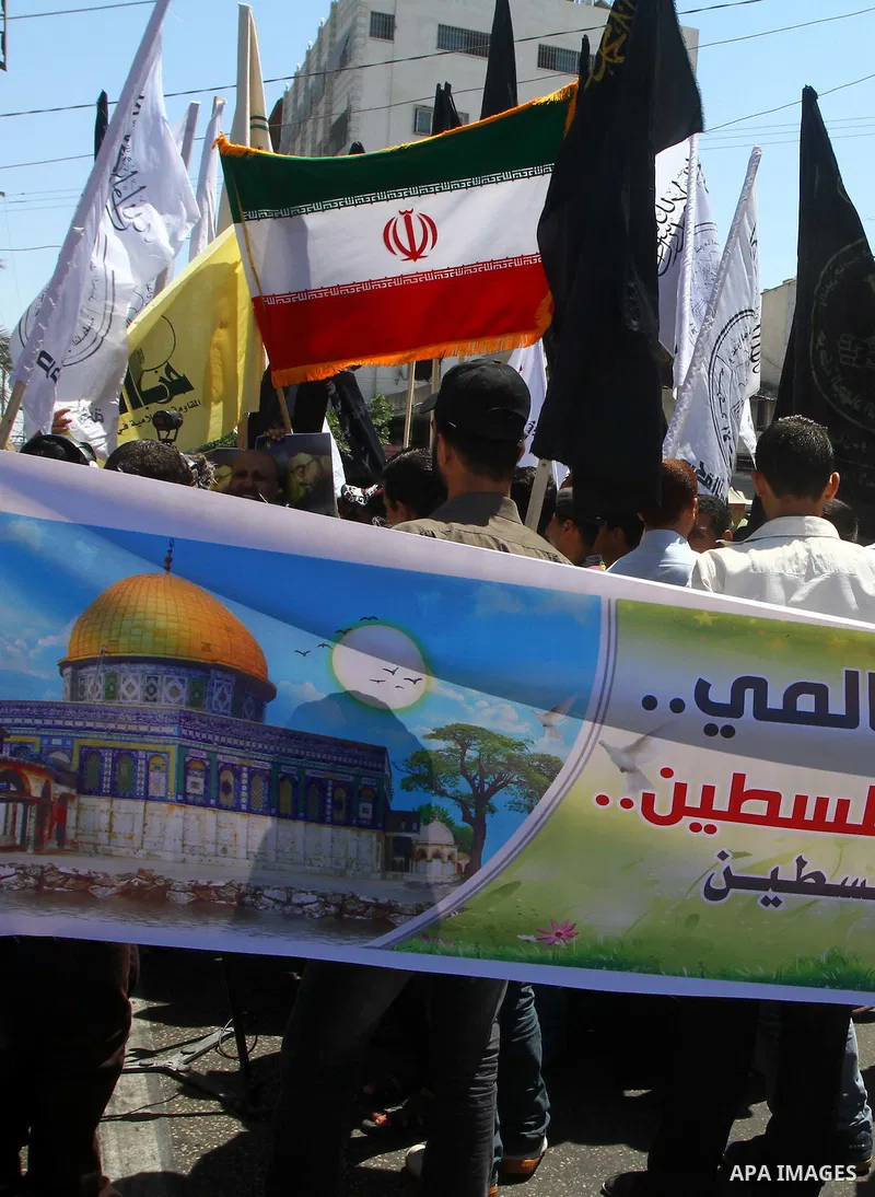 Palestinians wave with Iran's flag as they mark Quds Day or Jerusalem Day in Gaza city, Friday, Aug. 26, 2011. The late Iranian leader Ayatollah Khomeni declared the last Friday of the Islamic fasting month of Ramadan as...
