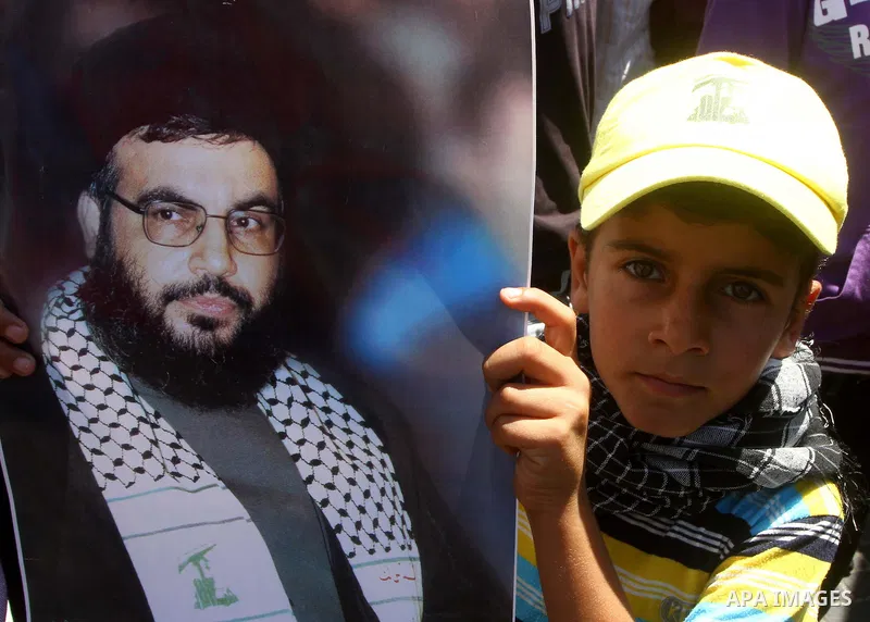 A Palestinian child holds a poster for Hezboallah leader Hassan Nassrallah during a protest to mark Quds Day or Jerusalem Day in Gaza city, Friday, Aug. 26, 2011. The late Iranian leader Ayatollah Khomeni declared the la...