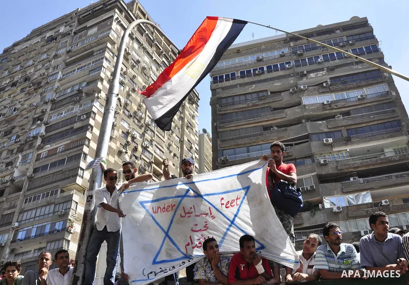 Egyptian protesters shout slogans against Israel during a protest in front of the Israeli Embassy in Cairo, Egypt, Friday, Aug.26, 2011. Hundreds of Egyptians protest the deaths of Egyptian security forces killed in a sh...