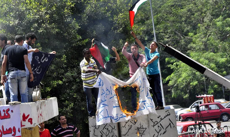 Egyptian protesters shout slogans against Israel during a protest in front of the Israeli Embassy in Cairo, Egypt, Friday, Aug.26, 2011. Hundreds of Egyptians protest the deaths of Egyptian security forces killed in a sh...