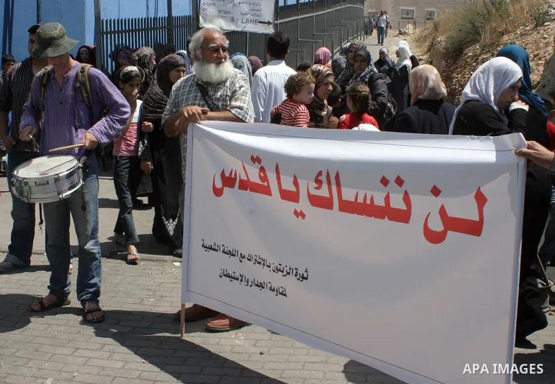Palestinian ,foreign and Israeli demonstrators take part in a protest at Israel's checkpoint outside the West Bank city of Bethlehem August 26, 2011. The demonstrators protested against Israel's occupation of the West Ba...