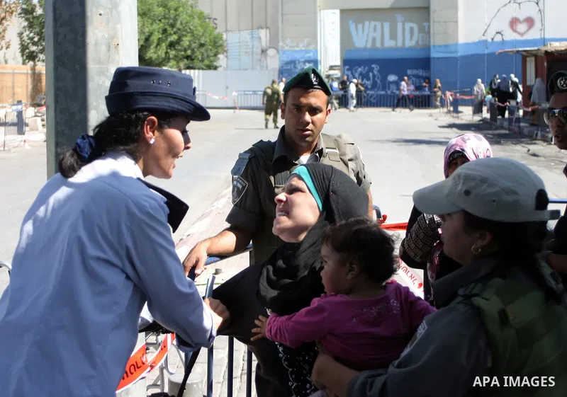 Palestinian women wait to pass the checkpoint on their way to pray at the Al Aqsa Mosque, on the last Friday of the Muslim holy month of Ramadan, in the West Bank town of Bethlehem, early Friday, Aug. 26, 2011. Muslims a...