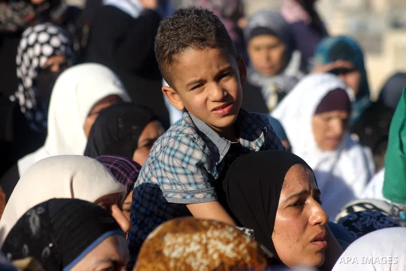 Palestinian women wait to pass the checkpoint on their way to pray at the Al Aqsa Mosque, on the last Friday of the Muslim holy month of Ramadan, in the West Bank town of Bethlehem, early Friday, Aug. 26, 2011. Muslims a...