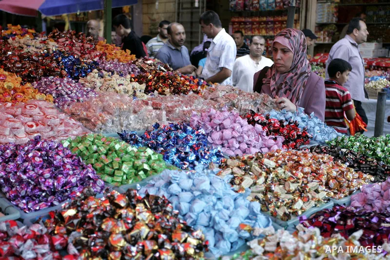Palestinians buy sweets as Muslims shop ahead of the Eid al-Fitr celebrations in Rafah, southern Gaza Strip on Aug. 28, 2011. Muslims in the region will celebrate the Eid al-Fitr holiday starting with the sighting of the...