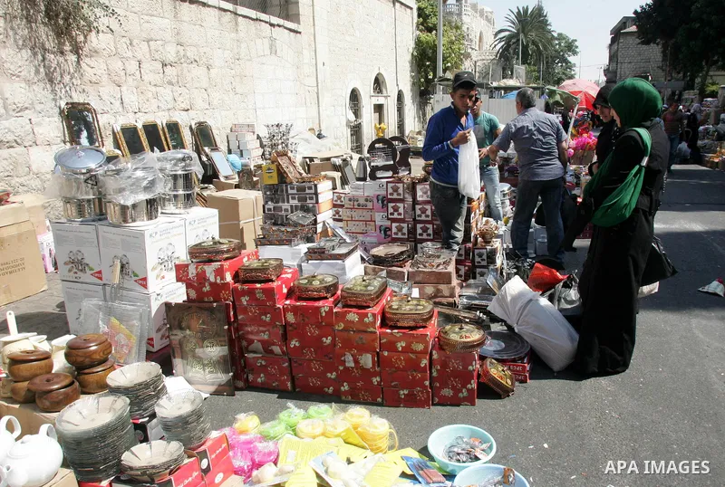 Palestinian vendors display their goods for sale during preparations for Eid aL-Fitr at the main market, in Jerusalem's old city 28 August 2011. Muslims throughout the world buy clothes and other popular items to prepare...