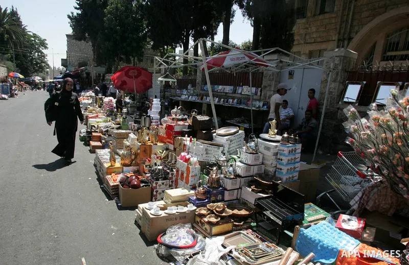 Palestinian vendors display their goods for sale during preparations for Eid aL-Fitr at the main market, in Jerusalem's old city 28 August 2011. Muslims throughout the world buy clothes and other popular items to prepare...