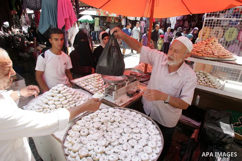 Palestinian vendors display their goods for sale during preparations for Eid aL-Fitr at the main market, in Jerusalem's old city 28 August 2011. Muslims throughout the world buy clothes and other popular items to prepare...
