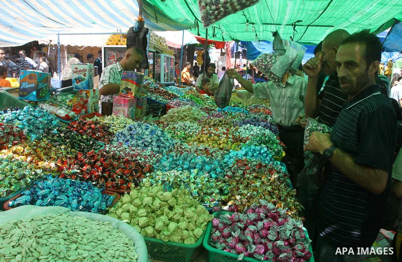 Palestinian vendors display their goods for sale during preparations for Eid aL-Fitr at the main market, in Gaza city 29 August 2011. Muslims throughout the world buy clothes, sweets and other popular items to prepare fo...