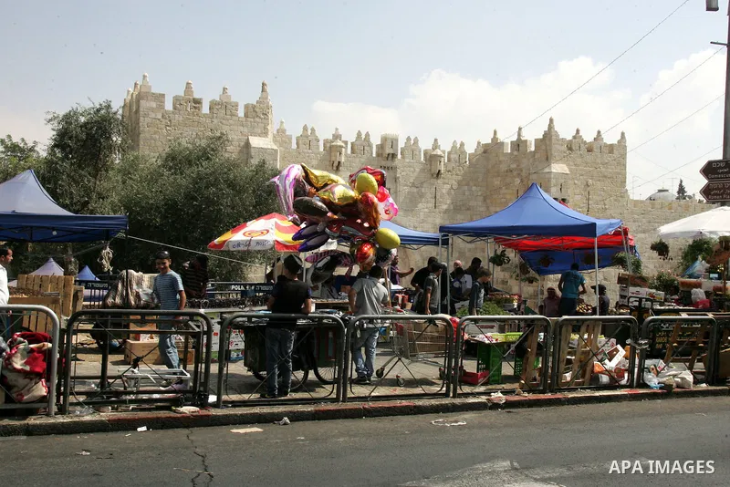 Palestinian vendors display their goods for sale during preparations for Eid aL-Fitr at the main market, in Jerusalem's old city 29 August 2011. Muslims throughout the world buy clothes, sweets and other popular items to...