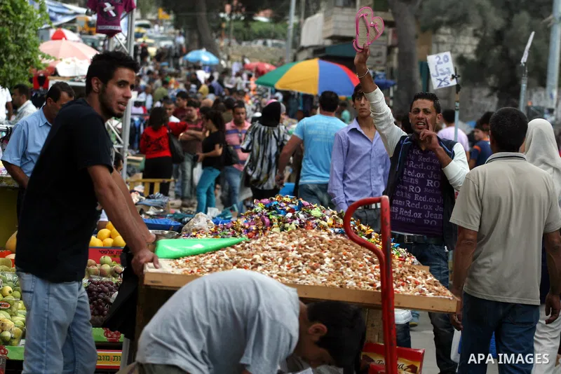 Palestinian Muslims shop in downtown Ramallah in the West Bank on August 29, 2011, ahead of the upcoming Eid al-Fitr which marks the end of the holy month of Ramadan. Photo by Issam Rimawi