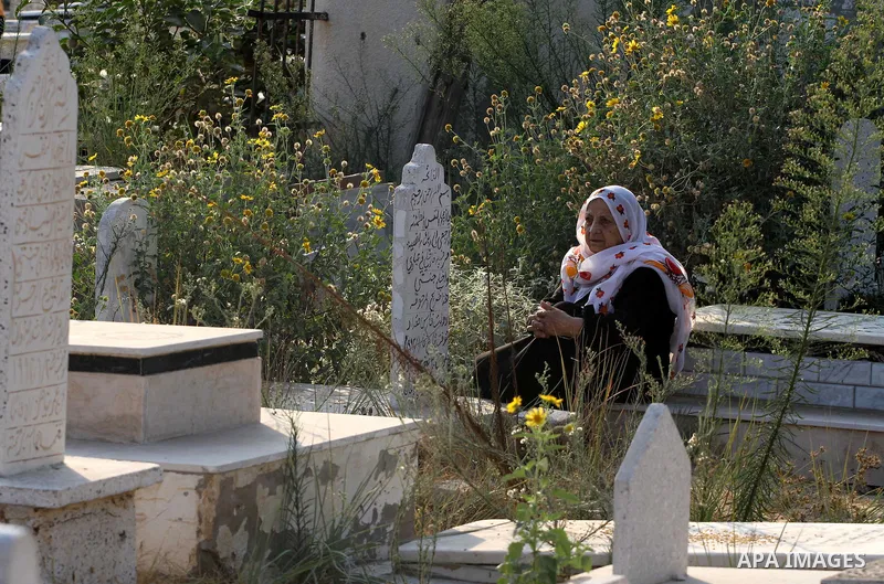 A Palestinians woman visits her relatives' graves in a cemetery during the first day of Eid al-Fitr in Gaza city on August 30, 2011. Eid al-Fitr marks the end of the Muslim holy month of Ramadan. Photo by Mohammed Asad