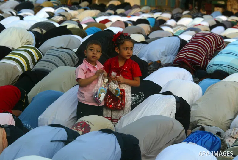 Palestinians attend an open air morning prayer to celebrate Eid al-Fitr in Khan Yunis town the southern Gaza Strip on August 30, 2011. The Palestinian Territories, along with other neighboring and Gulf states, announced...