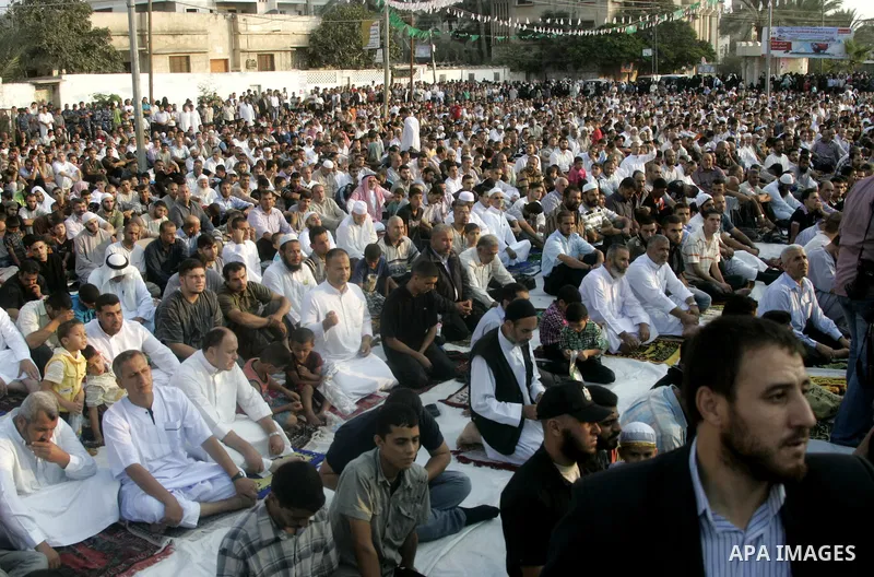 Palestinians attend an open air morning prayer to celebrate Eid al-Fitr in Khan Yunis town the southern Gaza Strip on August 30, 2011. The Palestinian Territories, along with other neighboring and Gulf states, announced...
