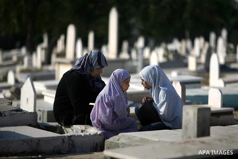 Palestinians visit their relatives' graves in a cemetery during the first day of Eid al-Fitr in the southern Gaza Strip on August 30, 2011. Eid al-Fitr marks the end of the Muslim holy month of Ramadan. Photo by Ali Jada...