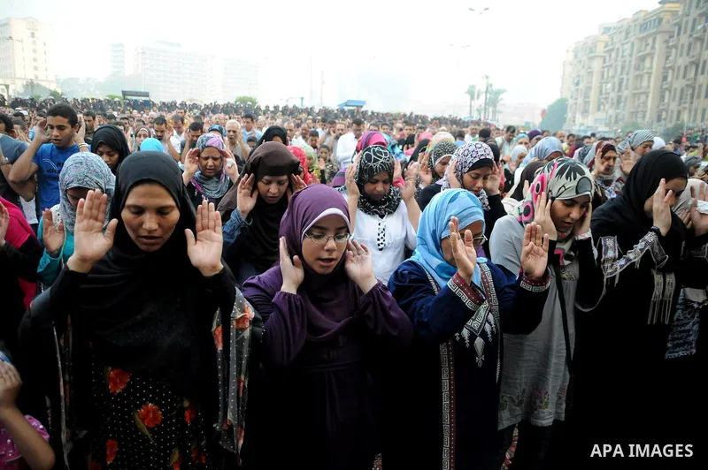 Egyptian Muslims gather to pray, celebrating the start of the three-day feast known in Arabic Eid al-Fitr, which marks the end of the holy fasting month of Ramadan, in Tahrir Square, the scene of mass demonstration which...
