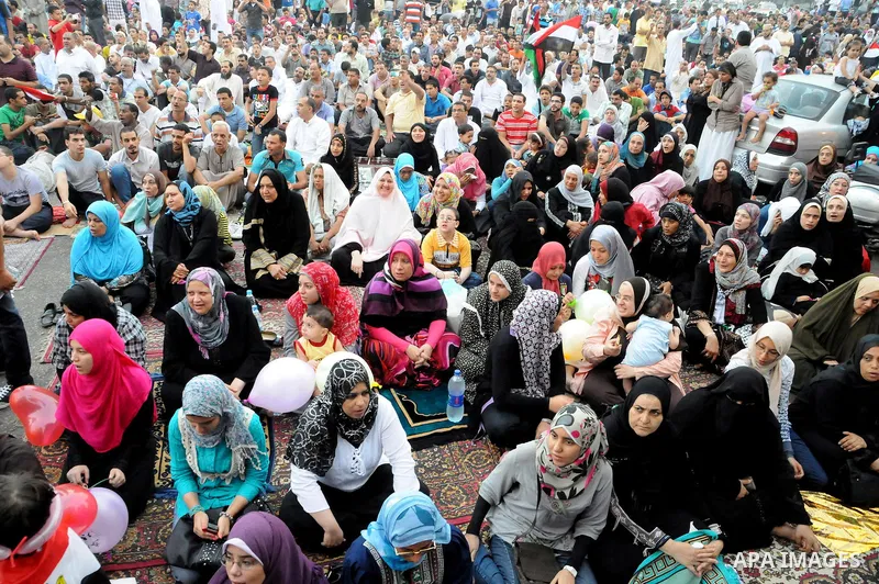 Egyptian Muslims gather to pray, celebrating the start of the three-day feast known in Arabic Eid al-Fitr, which marks the end of the holy fasting month of Ramadan, in Tahrir Square, the scene of mass demonstration which...