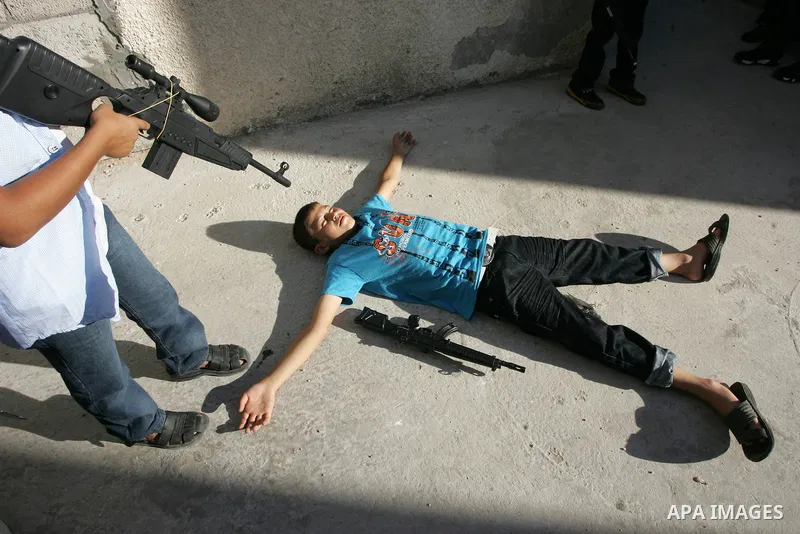 Palestinian boys play with toy guns on the third day of the Eid al-Fitr holiday in Rafah Refugee Camp in the southern Gaza Strip on 01 September 2011. Eid marks the end of the holy month of Ramadan. Photo by Abed Rahim K...