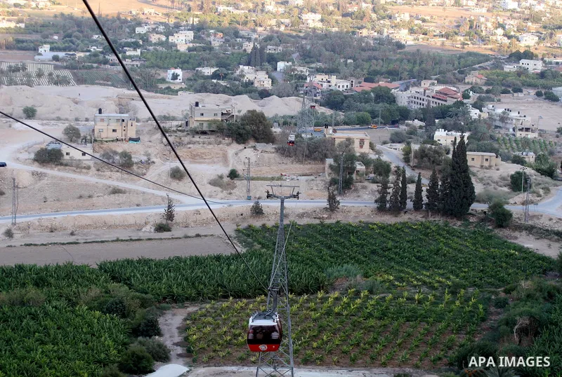 Tourists tour the historic sites of Jericho in cable cars during celebrations on the third day of the Eid al-Fitr holiday, which marks the end of the holy fasting month of Ramadan in the West Bank city of Jericho on Sept...