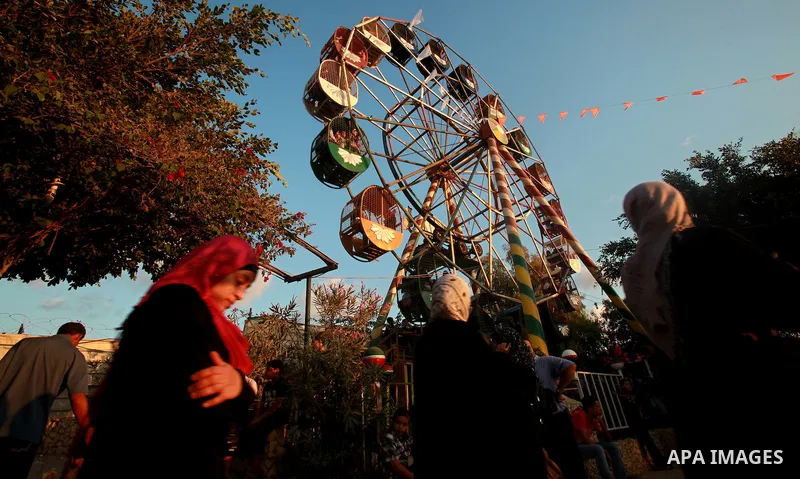 Palestinian children enjoy a ride at an amusement park on the third day of the Eid al-Fitr holiday, which marks the end of the holy fasting month of Ramadan in Gaza city on Sept. 1,2011. Photo by Ashraf Amra