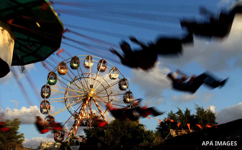 Palestinian children enjoy a ride at an amusement park on the third day of the Eid al-Fitr holiday, which marks the end of the holy fasting month of Ramadan in Gaza city on Sept. 1,2011. Photo by Ashraf Amra