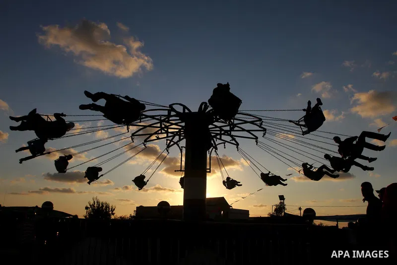Palestinian children enjoy a ride at an amusement park on the third day of the Eid al-Fitr holiday, which marks the end of the holy fasting month of Ramadan in Gaza city on Sept. 1,2011. Photo by Ashraf Amra