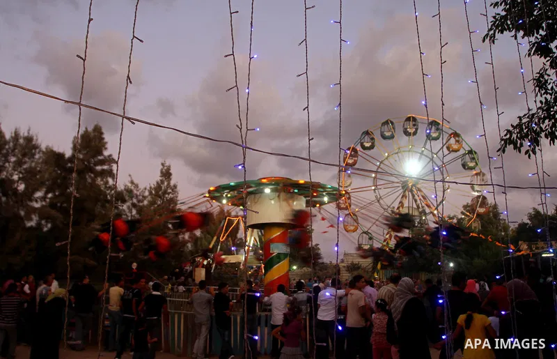 Palestinian children enjoy a ride at an amusement park on the third day of the Eid al-Fitr holiday, which marks the end of the holy fasting month of Ramadan in Gaza city on Sept. 1,2011. Photo by Ashraf Amra