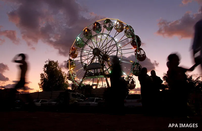 Palestinian children enjoy a ride at an amusement park on the third day of the Eid al-Fitr holiday, which marks the end of the holy fasting month of Ramadan in Gaza city on Sept. 1,2011. Photo by Ashraf Amra