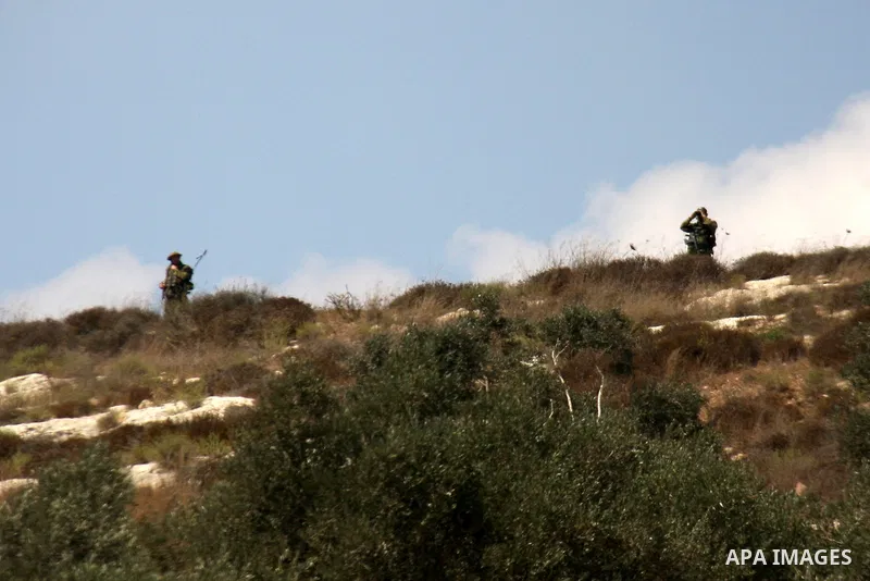 Israeli soldiers stand guard during clashes with Palestinian demonstrators following a protest against the closure of a road during the second Intifada (uprising) by Jewish settlers from the nearby settlement of Kadumim...