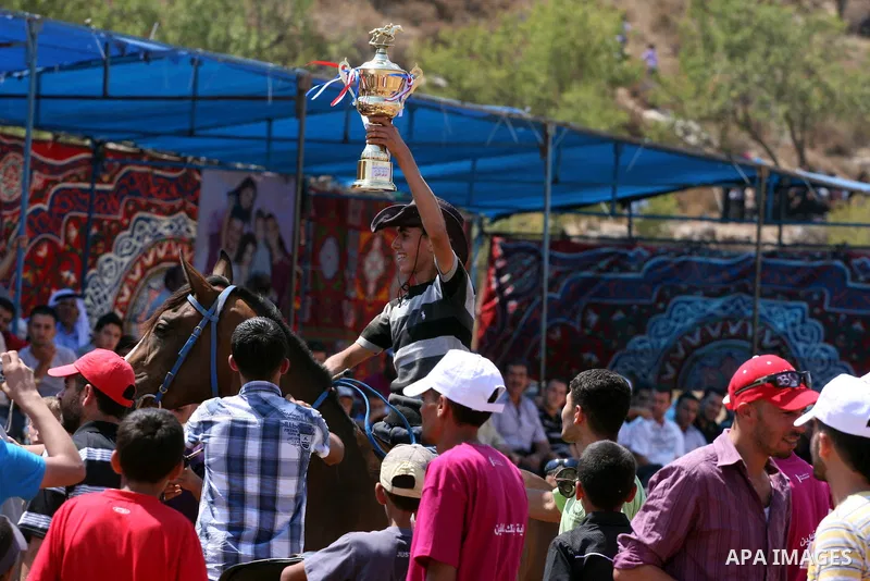 Palestinian jockeys compete during a horse race in the West Bank village of Abu Falah, near the town of Ramallah ,on 02 September 2011. Some 60 horses in different heats participated in races through the day, attracting...
