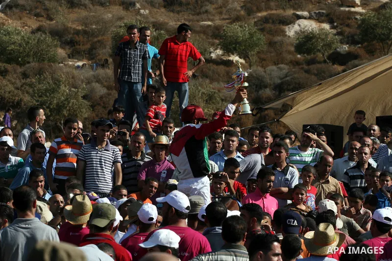 Palestinian jockeys compete during a horse race in the West Bank village of Abu Falah, near the town of Ramallah ,on 02 September 2011. Some 60 horses in different heats participated in races through the day, attracting...