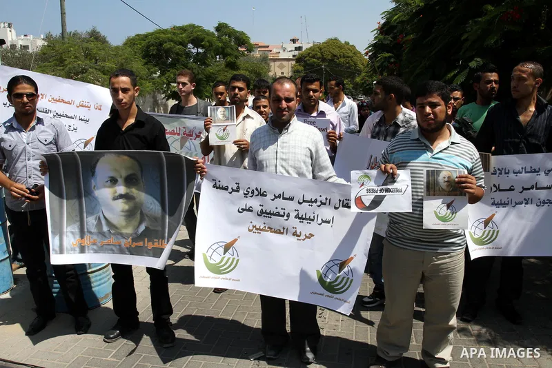 Palestinian journalists take part in a protest in support with the journalist, Samir Allawi, Al-Jazeera correspondent in Afghanistan and his fellow journalists detained in Israeli prisons, infront of UNRWA headquarters i...